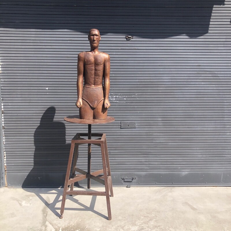 anonymous wooden sculpture of a swimmer wearing a swimsuit