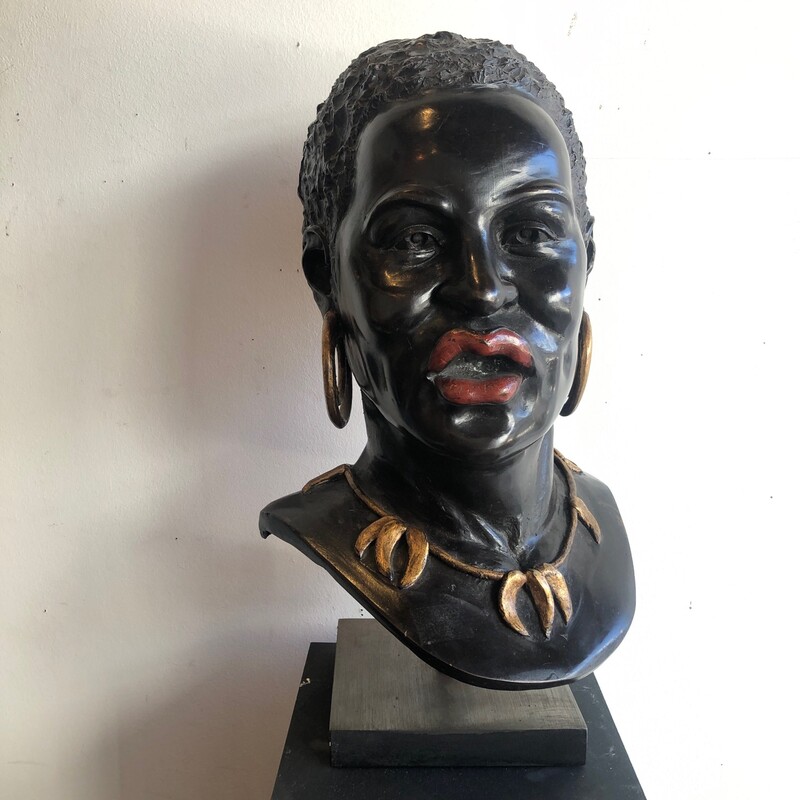 bronze sculpture of an african wearing a necklace and earrings